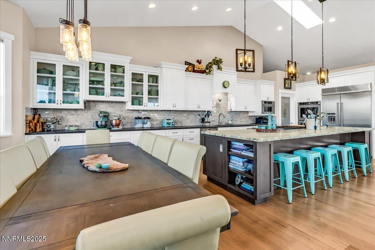 4610 Tybo Road Reno, NV 89521 - Photo 12 of 47 a kitchen with a table chairs stove and cabinets