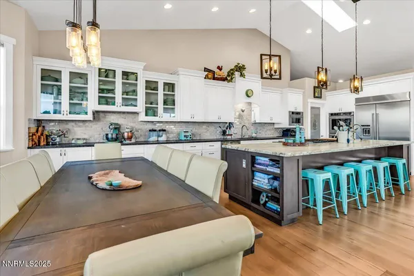 a kitchen with a table chairs stove and cabinets