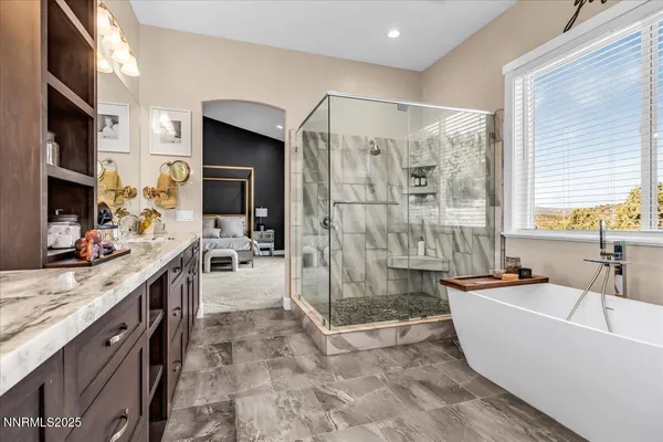 a large white kitchen with a granite countertop sink and a large window
