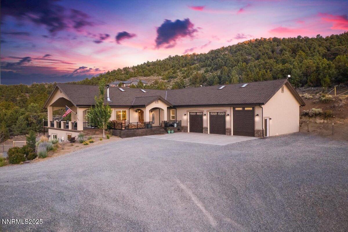 4610 Tybo Road Reno, NV 89521 - Photo 2 of 47 a front view of a house with a yard and garage