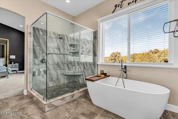 a white bath tub sitting next to a shower
