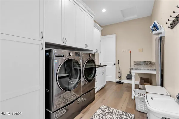 a utility room with sink dryer and washer