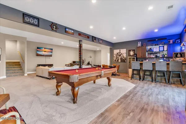 a living room with lots of furniture and a wooden floor
