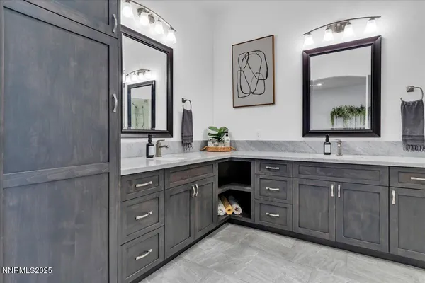 a bathroom with a double vanity sink and a mirror