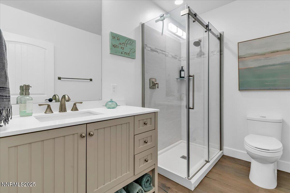 4610 Tybo Road Reno, NV 89521 - Photo 31 of 47 a bathroom with a double vanity sink toilet and shower