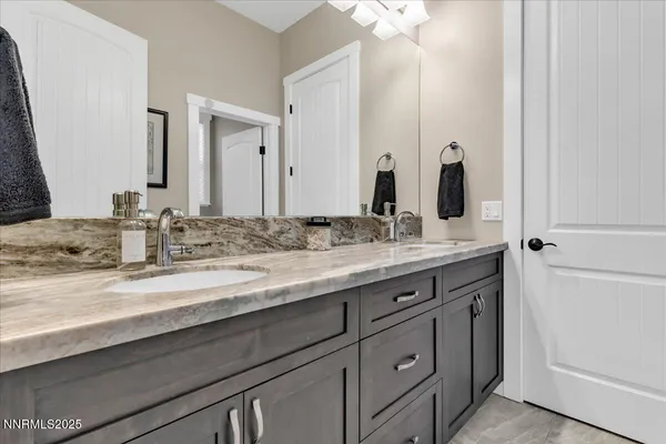a bathroom with double sink and a mirror