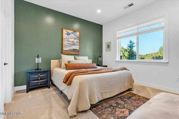 a bedroom with a bed and a painting on the wall