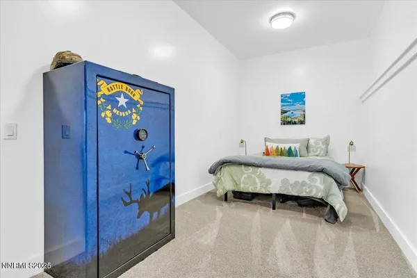 a bedroom with a bed and a painting on the wall