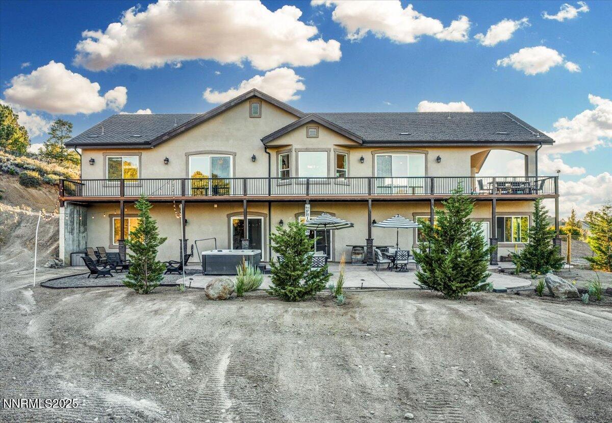 4610 Tybo Road Reno, NV 89521 - Photo 43 of 47 a view of a house with potted plants and a car park side of it