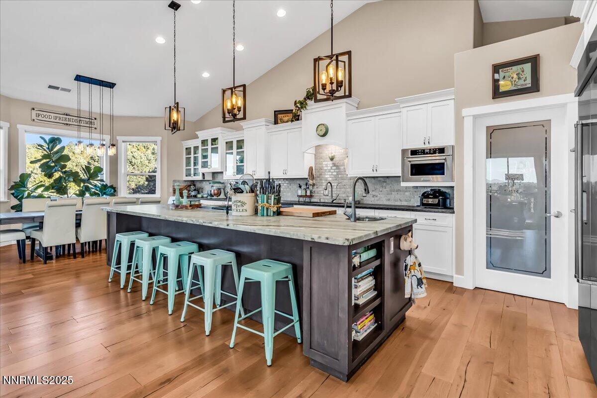 4610 Tybo Road Reno, NV 89521 - Photo 5 of 47 a kitchen with stainless steel appliances granite countertop a stove a refrigerator a kitchen island a sink and a wooden cabinets