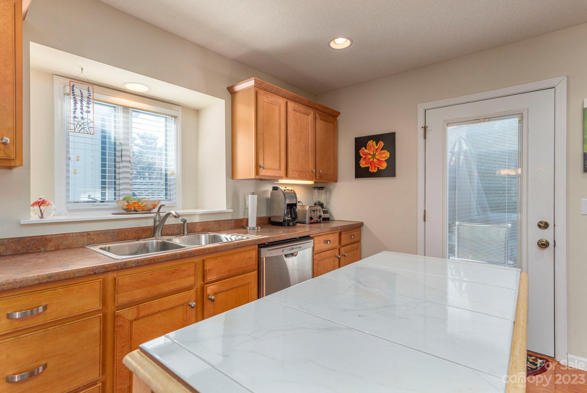448 Kyfields Weaverville, NC 28787 - Photo 12 of 25 a kitchen with granite countertop sink stainless steel appliances and window