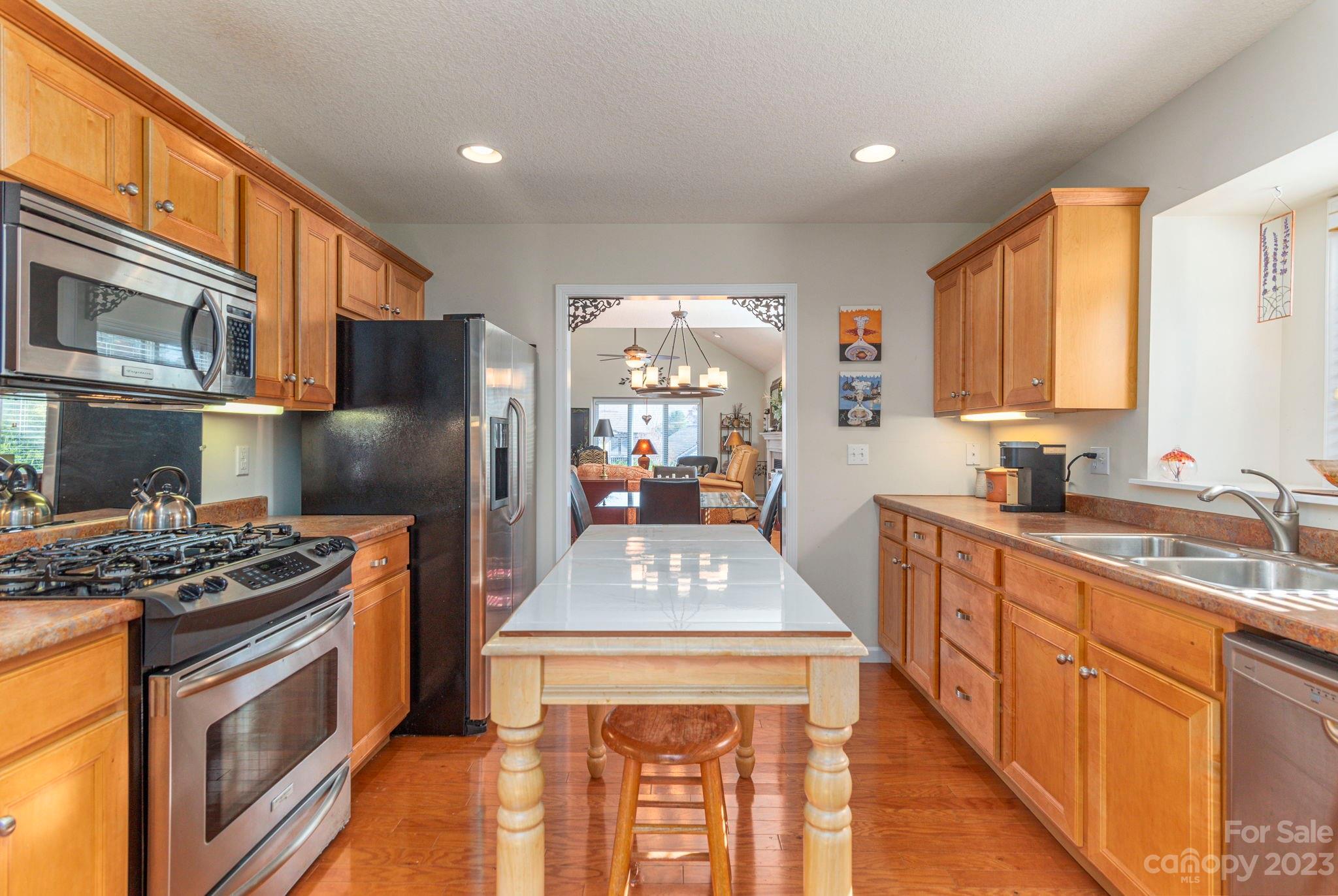 448 Kyfields Weaverville, NC 28787 - Photo 13 of 25 a kitchen with stainless steel appliances granite countertop a stove a sink dishwasher and a refrigerator