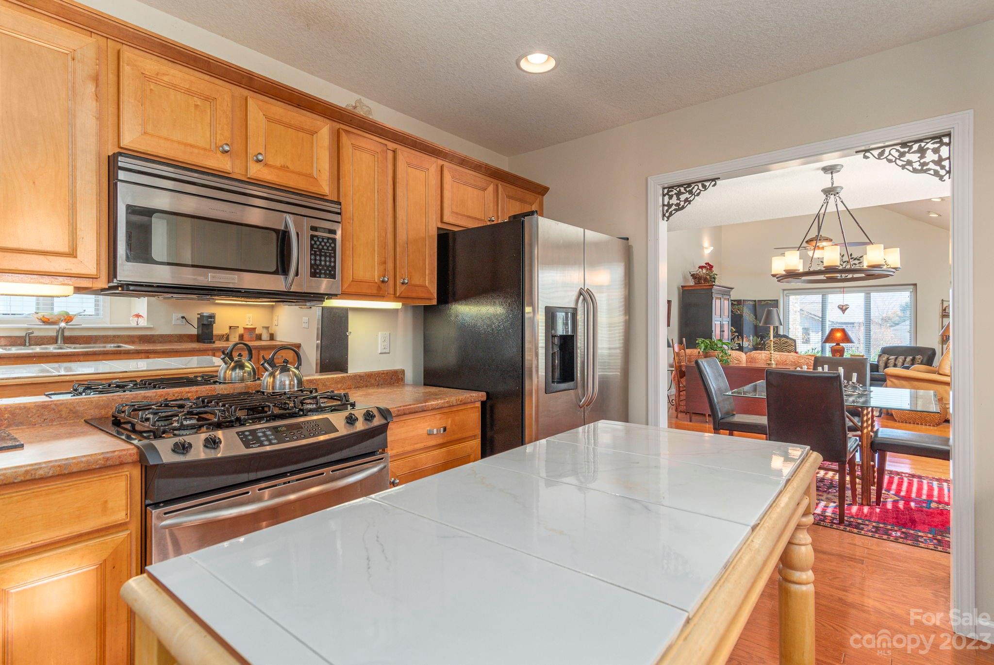 448 Kyfields Weaverville, NC 28787 - Photo 14 of 25 a kitchen with stainless steel appliances granite countertop a stove a sink dishwasher and a refrigerator