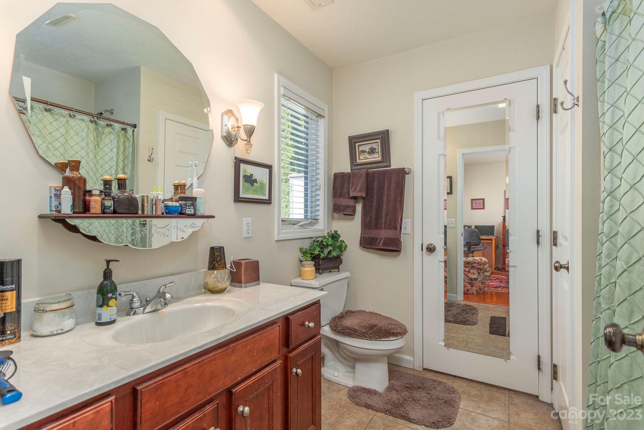 448 Kyfields Weaverville, NC 28787 - Photo 16 of 25 a bathroom with a toilet a sink and shower