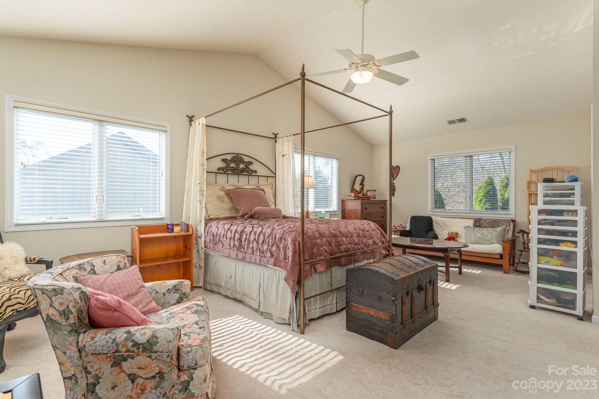 448 Kyfields Weaverville, NC 28787 - Photo 19 of 25 a bedroom with a bed and a chandelier