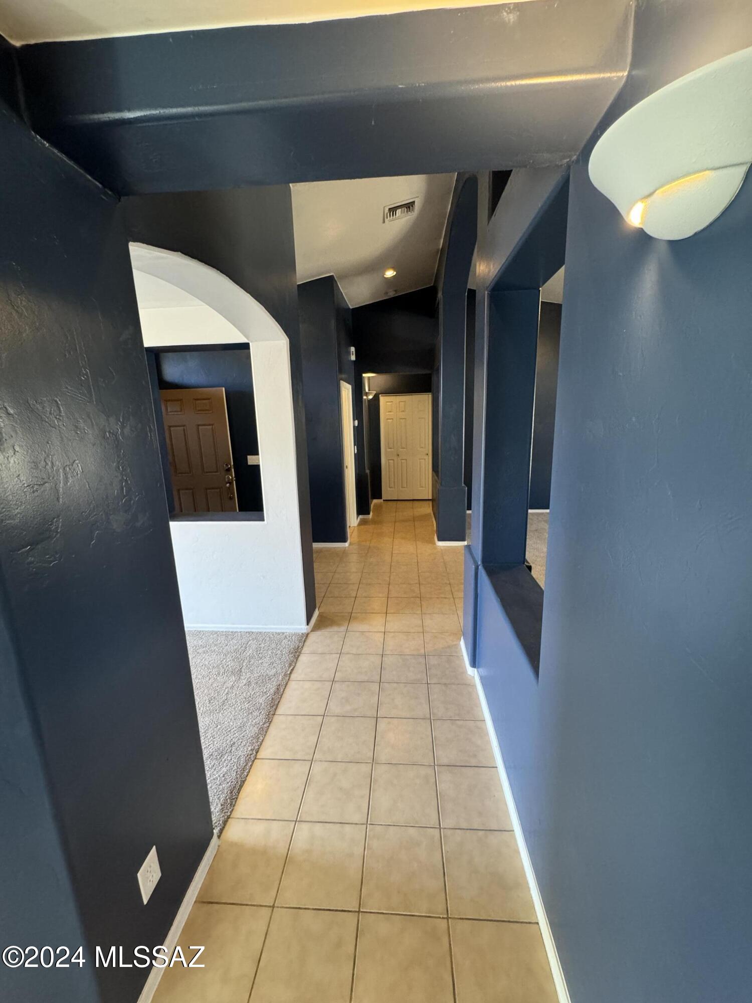 1841 America Court Rio Rico, AZ 85648 - Photo 13 of 38 a hallway with a white wooden cabinets
