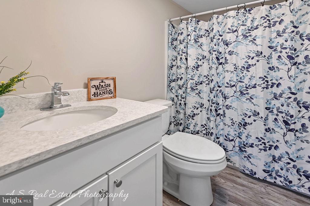 34820 Bi State Boulevard Delmar, DE 19940 - Photo 14 of 15 a bathroom with a granite countertop toilet and a sink