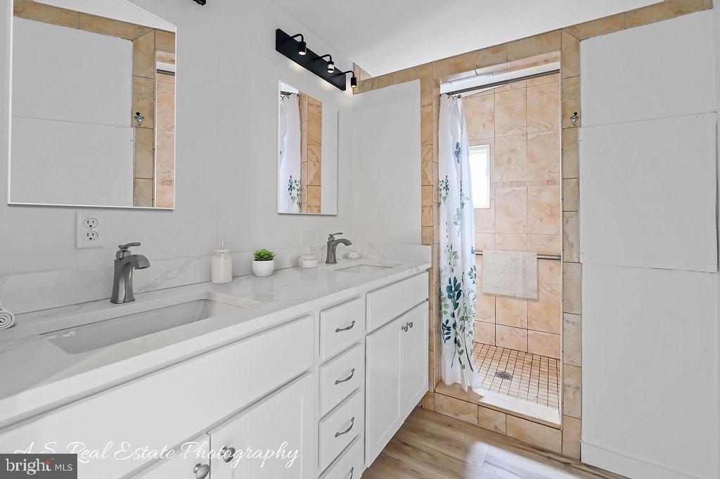 34820 Bi State Boulevard Delmar, DE 19940 - Photo 10 of 15 a bathroom with double vanity sink and a shower