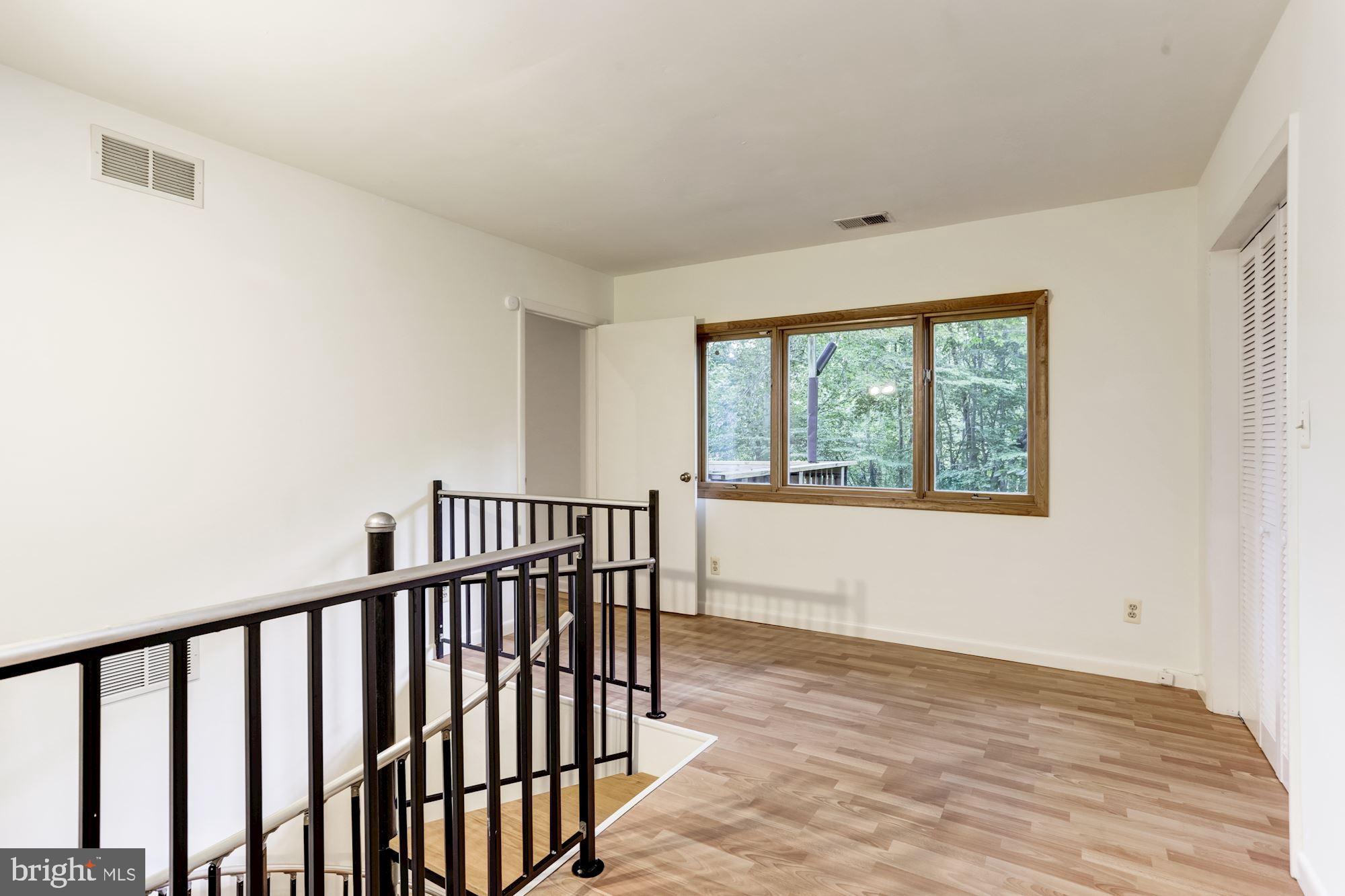 4511 Clifton Road Baltimore, MD 21216 - Photo 17 of 35 a view of wooden floor in a room