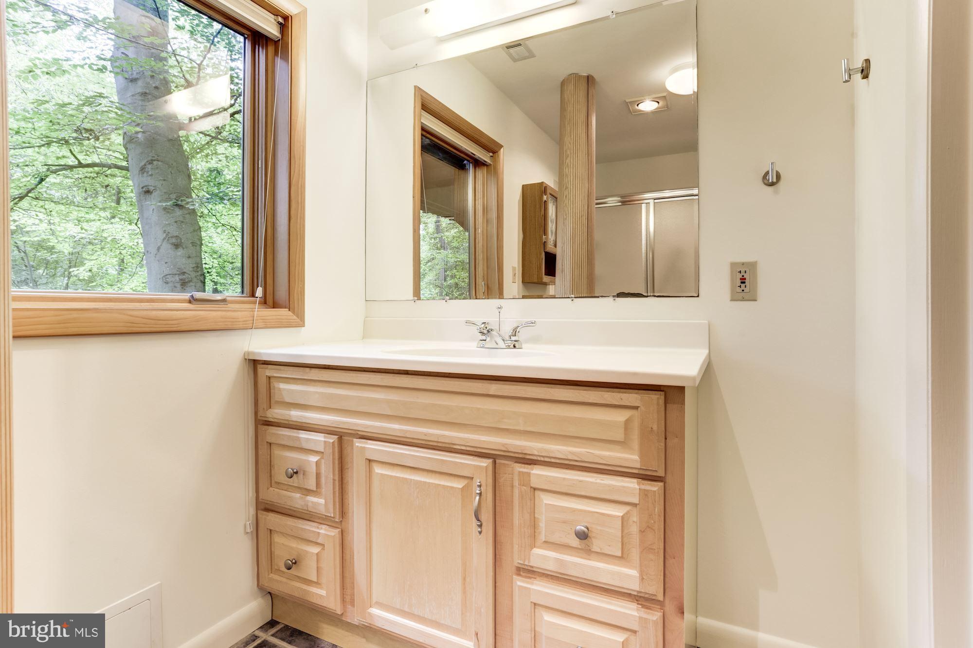 4511 Clifton Road Baltimore, MD 21216 - Photo 21 of 35 a bathroom with a sink a vanity and a mirror