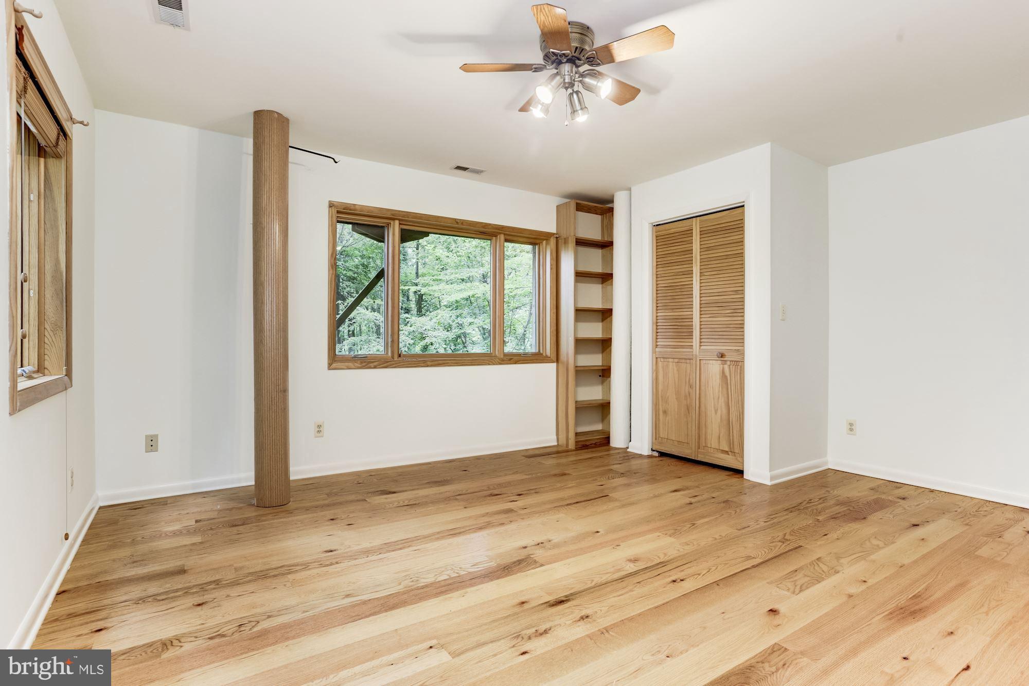 4511 Clifton Road Baltimore, MD 21216 - Photo 23 of 35 a view of empty room with wooden floor and fan