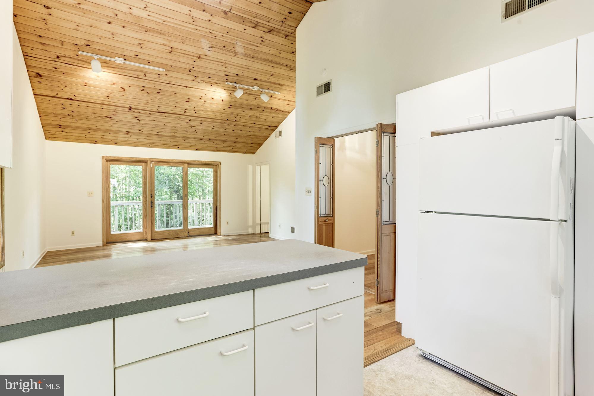 4511 Clifton Road Baltimore, MD 21216 - Photo 5 of 35 a kitchen with refrigerator and window