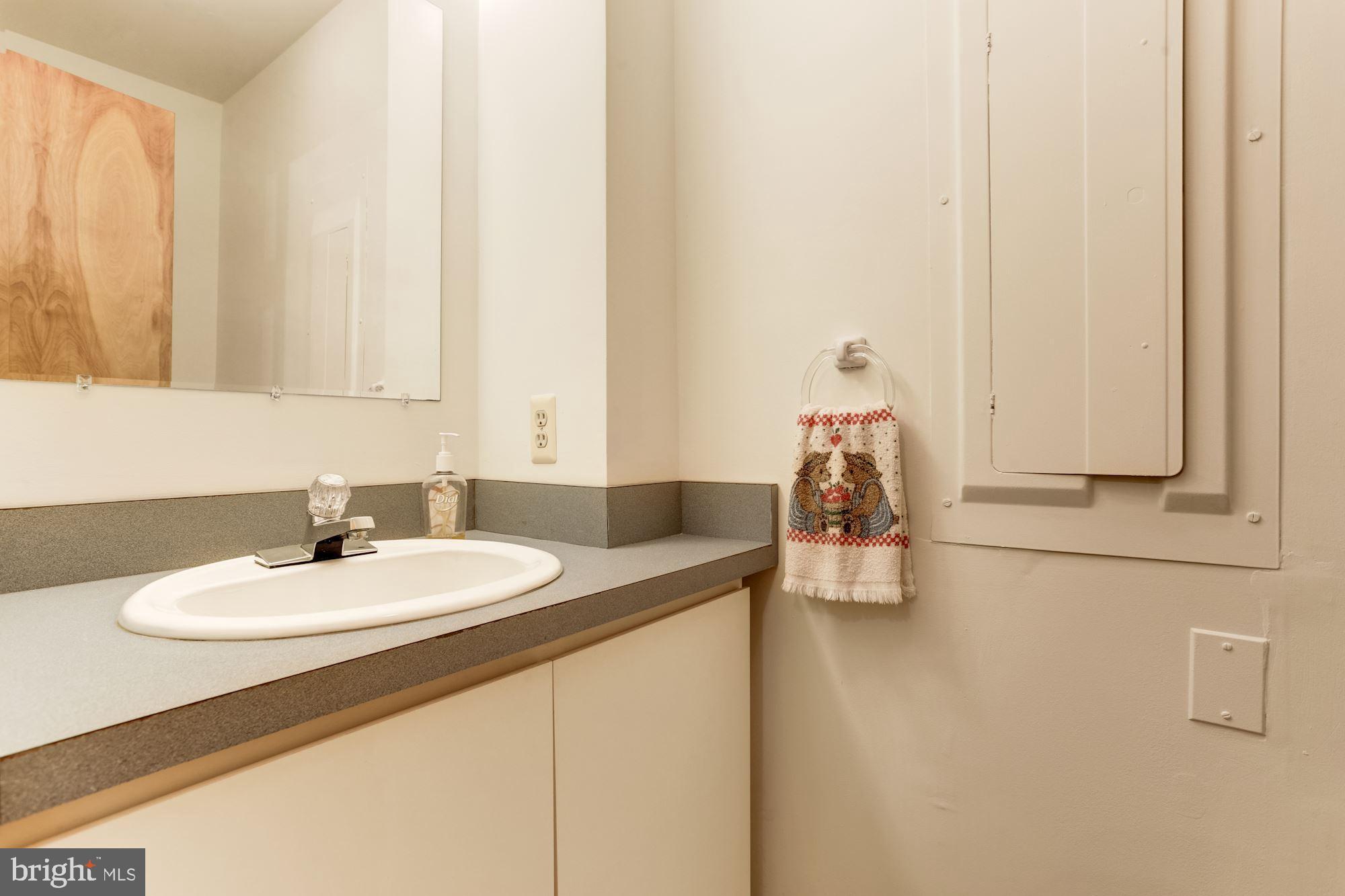 4511 Clifton Road Baltimore, MD 21216 - Photo 10 of 35 a bathroom with a sink and a mirror