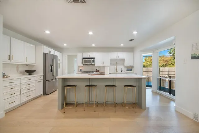 a large kitchen with a stove top oven