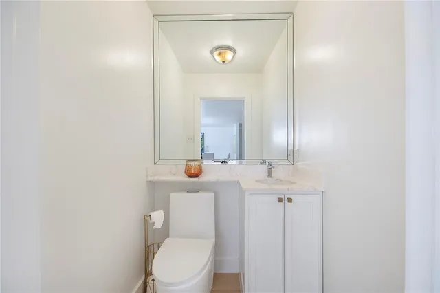 a kitchen with stainless steel appliances granite countertop a sink stove refrigerator and cabinets