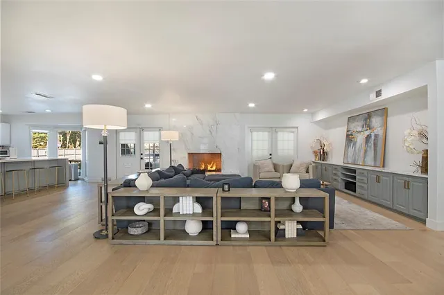 a living room with furniture and a view of kitchen