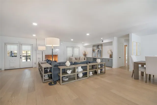 a large kitchen with a sink and dishwasher a oven with white cabinets