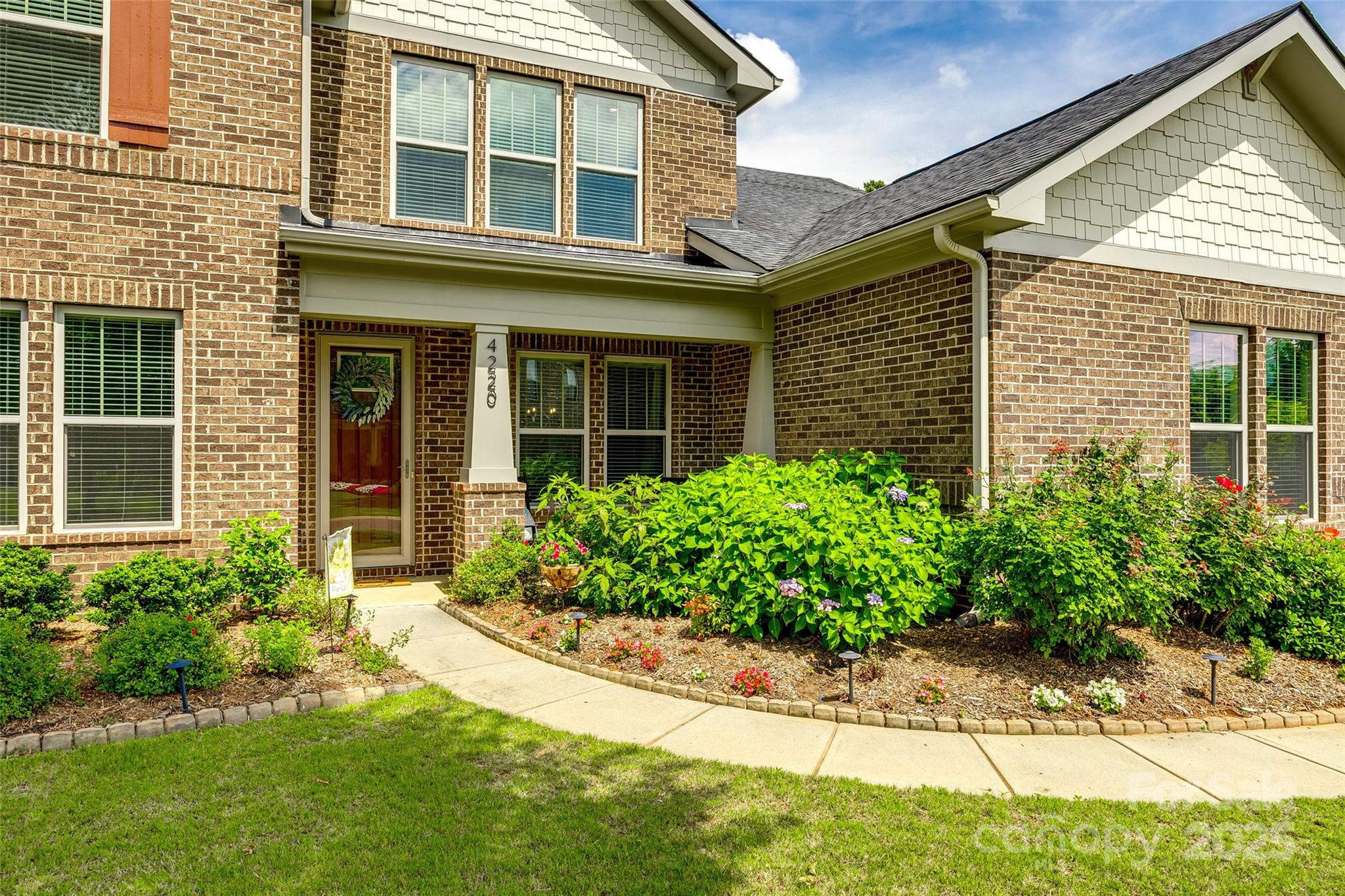 4220 Thames Circle Fort Mill, SC 29715 - Photo 2 of 44 front view of a brick house with a yard