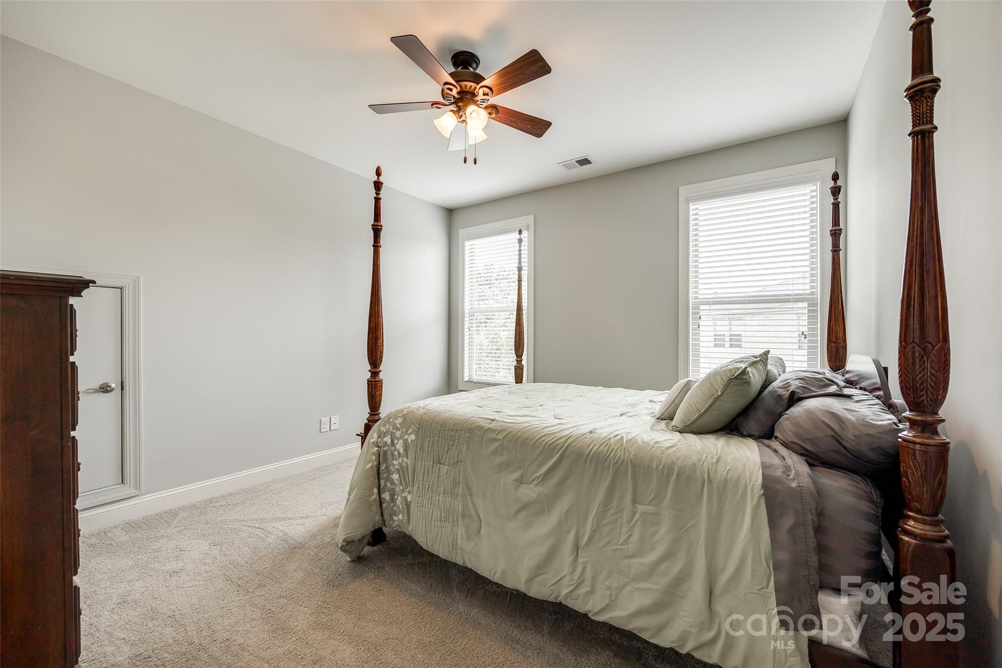 4220 Thames Circle Fort Mill, SC 29715 - Photo 24 of 44 a bedroom with a bed and a chandelier