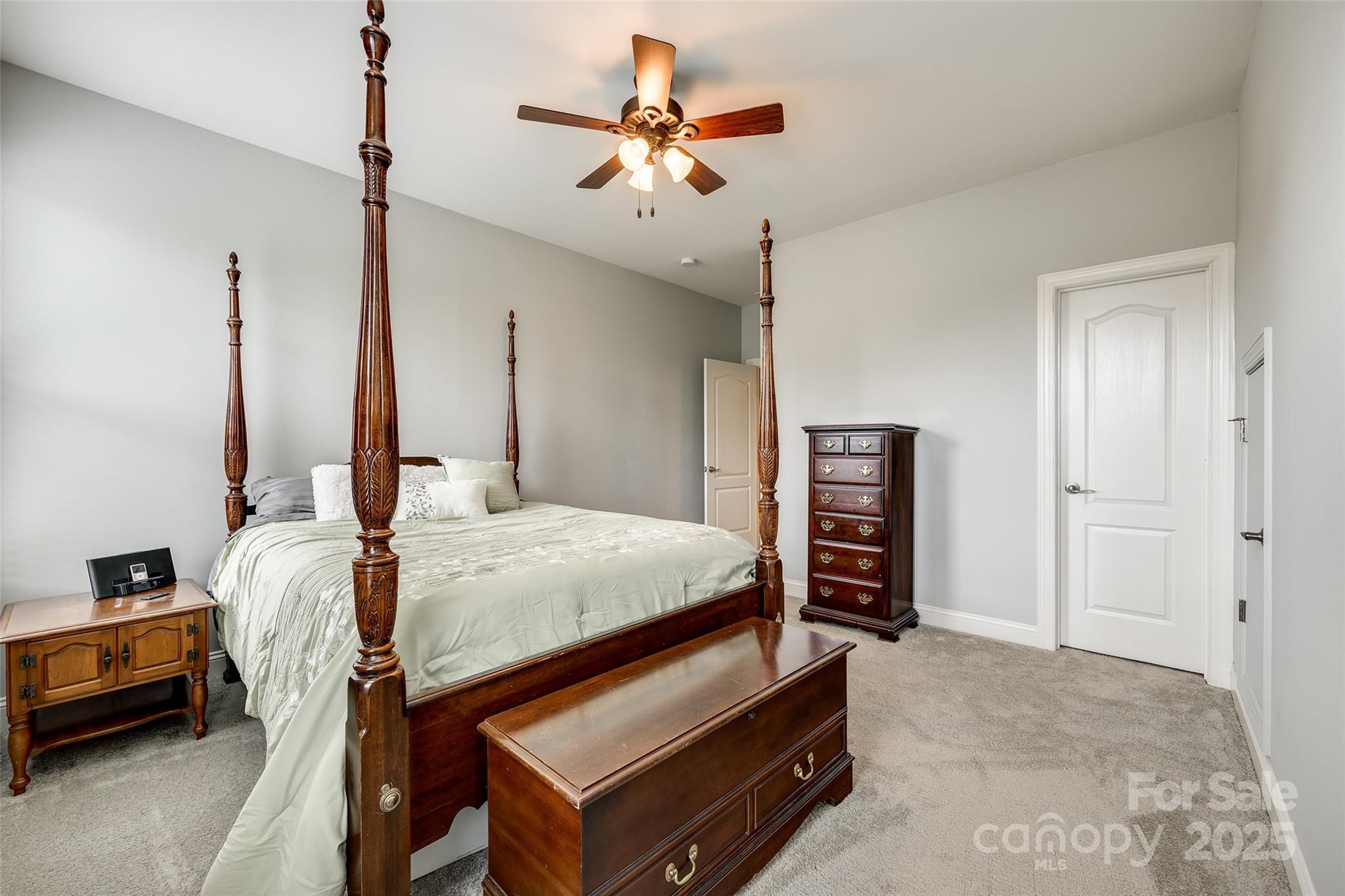 4220 Thames Circle Fort Mill, SC 29715 - Photo 25 of 44 a bedroom with a bed and a chandelier