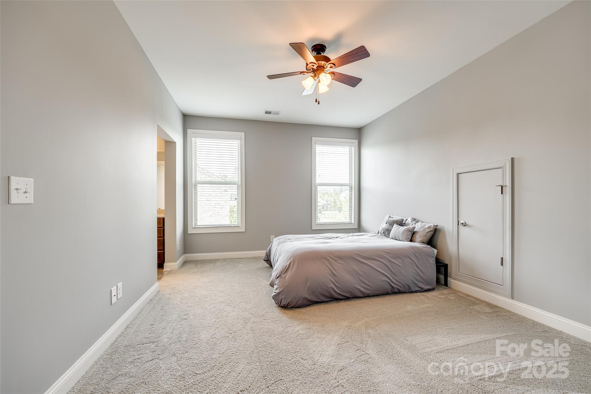 4220 Thames Circle Fort Mill, SC 29715 - Photo 29 of 44 a bedroom with a bed and a chandelier