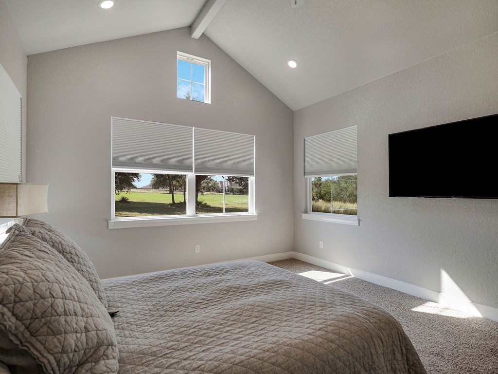 238 Roy Nichols Blanco, TX 78606 - Photo 13 of 25 a bedroom with a bed and a flat screen tv