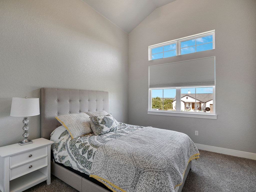 238 Roy Nichols Blanco, TX 78606 - Photo 17 of 25 a bedroom with a bed and a painting on the wall