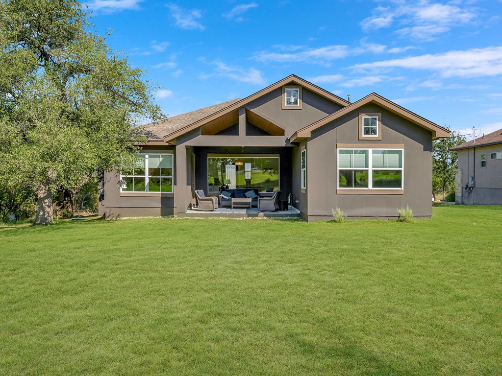 238 Roy Nichols Blanco, TX 78606 - Photo 24 of 25 a front view of a house with a garden and trees