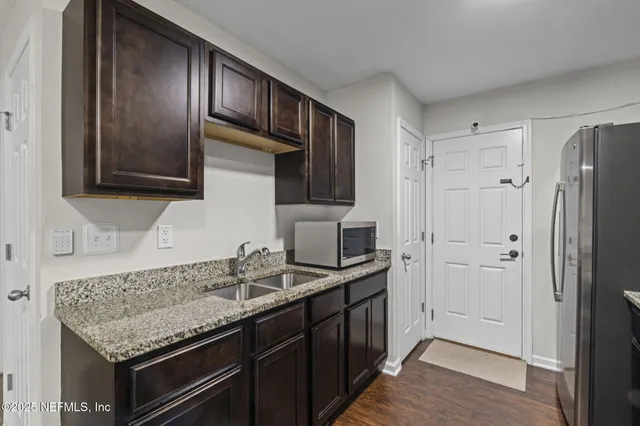 a kitchen with granite countertop stainless steel appliances and wooden cabinets