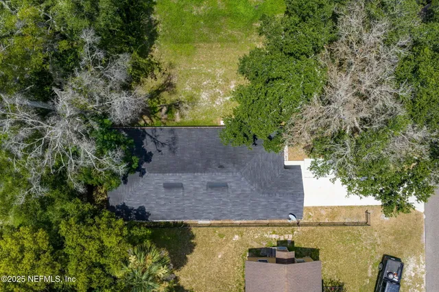 an aerial view of a house with a yard