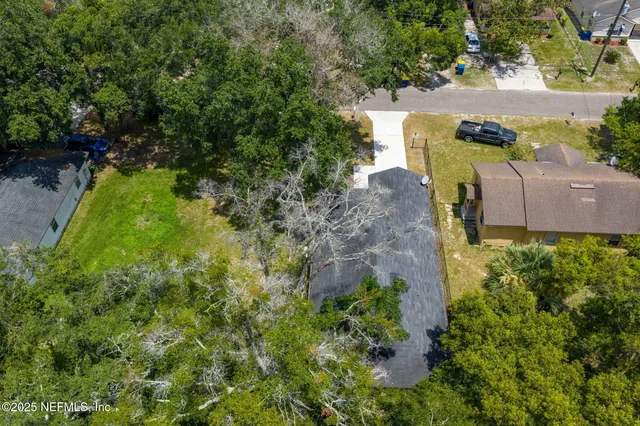 an aerial view of a house with a yard