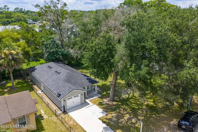 an aerial view of a house with a yard