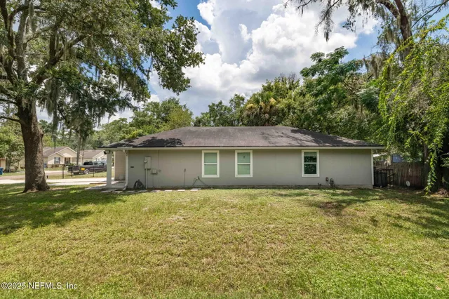 a house that has a tree in front of it