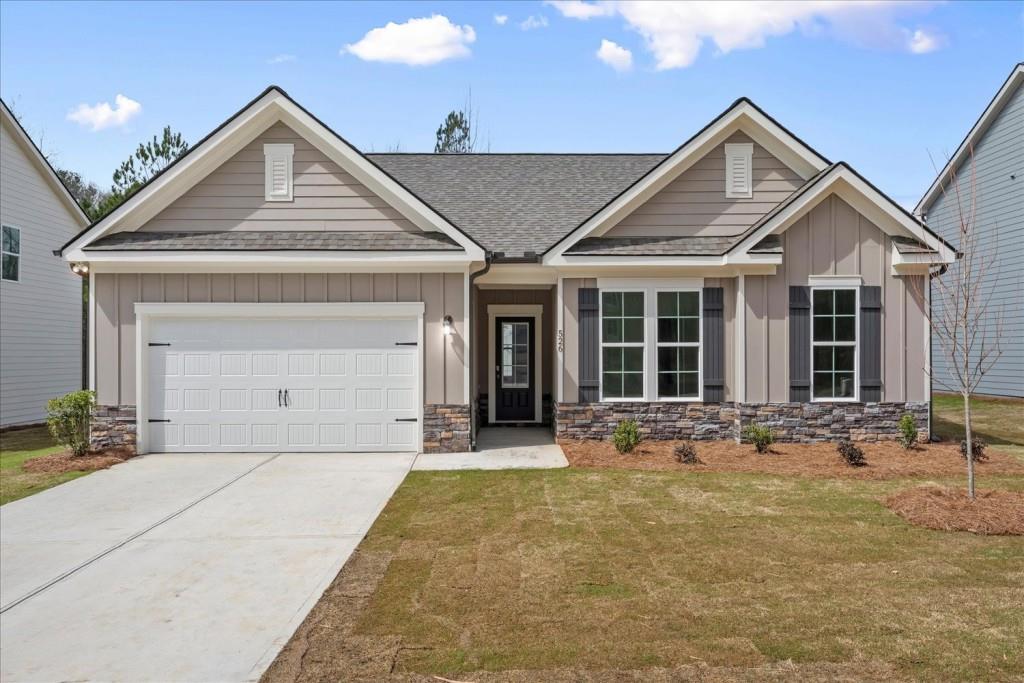 526 Lillian Way Statham, GA 30666 - Photo 1 of 56 a front view of a house with a yard and garage