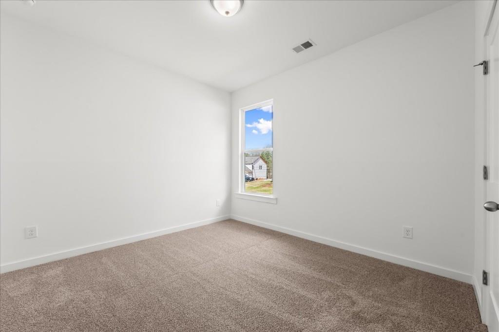 526 Lillian Way Statham, GA 30666 - Photo 11 of 56 a view of an empty room with a window
