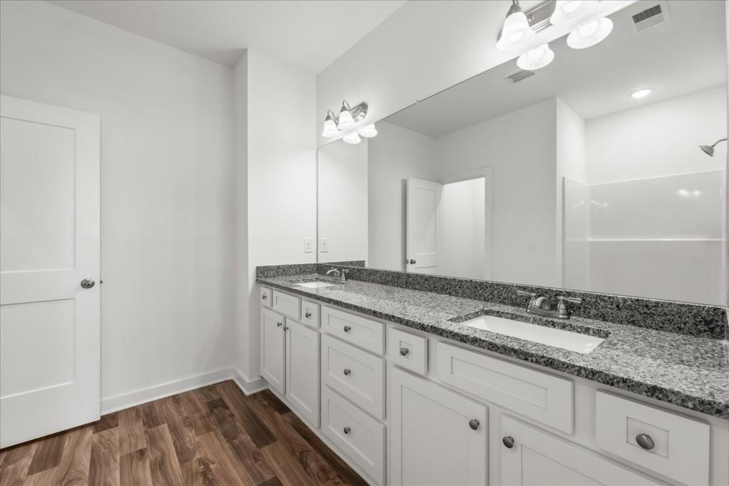 526 Lillian Way Statham, GA 30666 - Photo 16 of 56 a bathroom with a granite countertop double vanity sink and a mirror