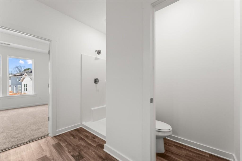 526 Lillian Way Statham, GA 30666 - Photo 18 of 56 a white toilet sitting next to a shower