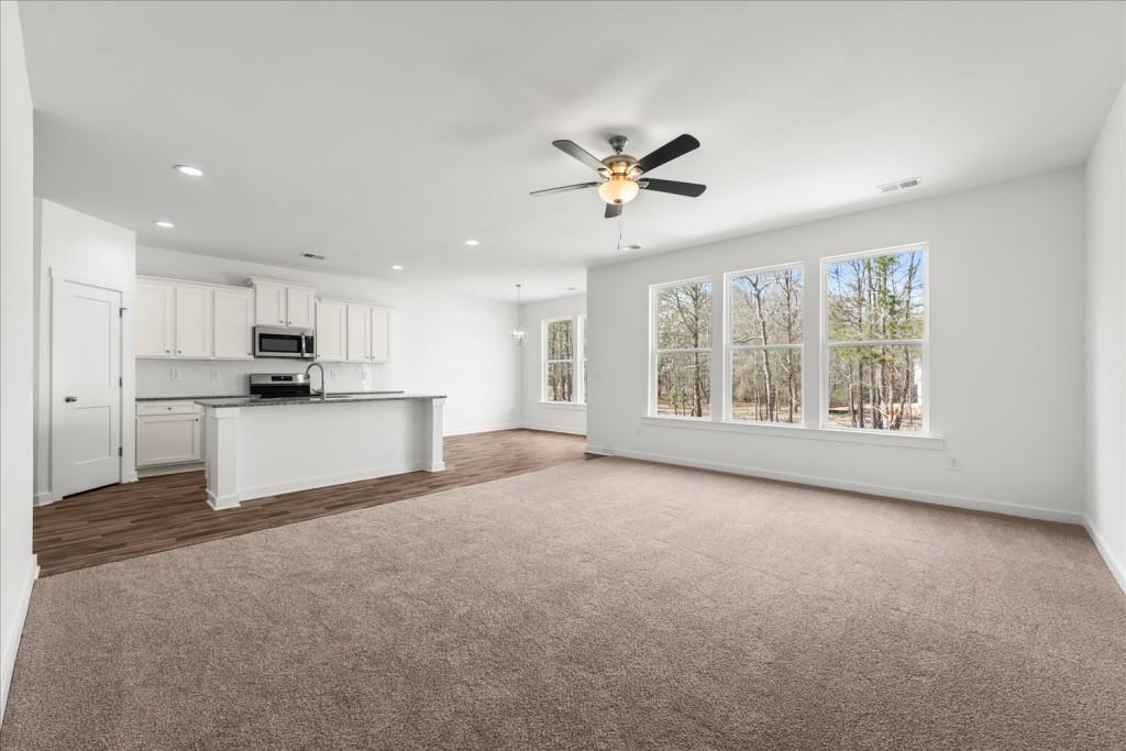 526 Lillian Way Statham, GA 30666 - Photo 22 of 56 a view of a kitchen with an empty space and a window