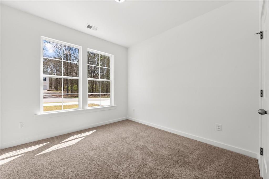 526 Lillian Way Statham, GA 30666 - Photo 7 of 56 a view of an empty room with a window