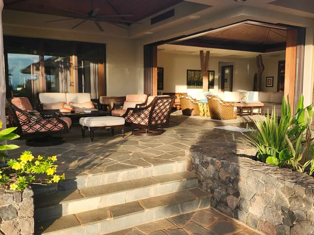 a dining room with stainless steel appliances granite countertop a kitchen island a table and chairs in it